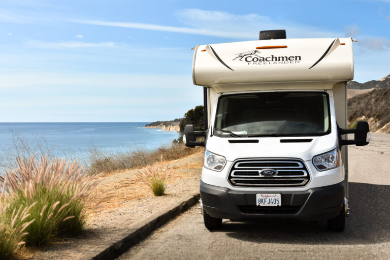 Class-C-camper-next-to-an-ocean-768x512